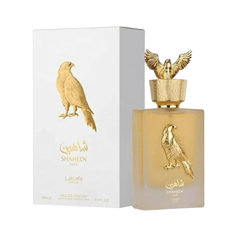 Perfume KingParfumCol Shaheen Gold con frasco de vidrio esmerilado, tapón dorado con águila y caja blanca a juego.